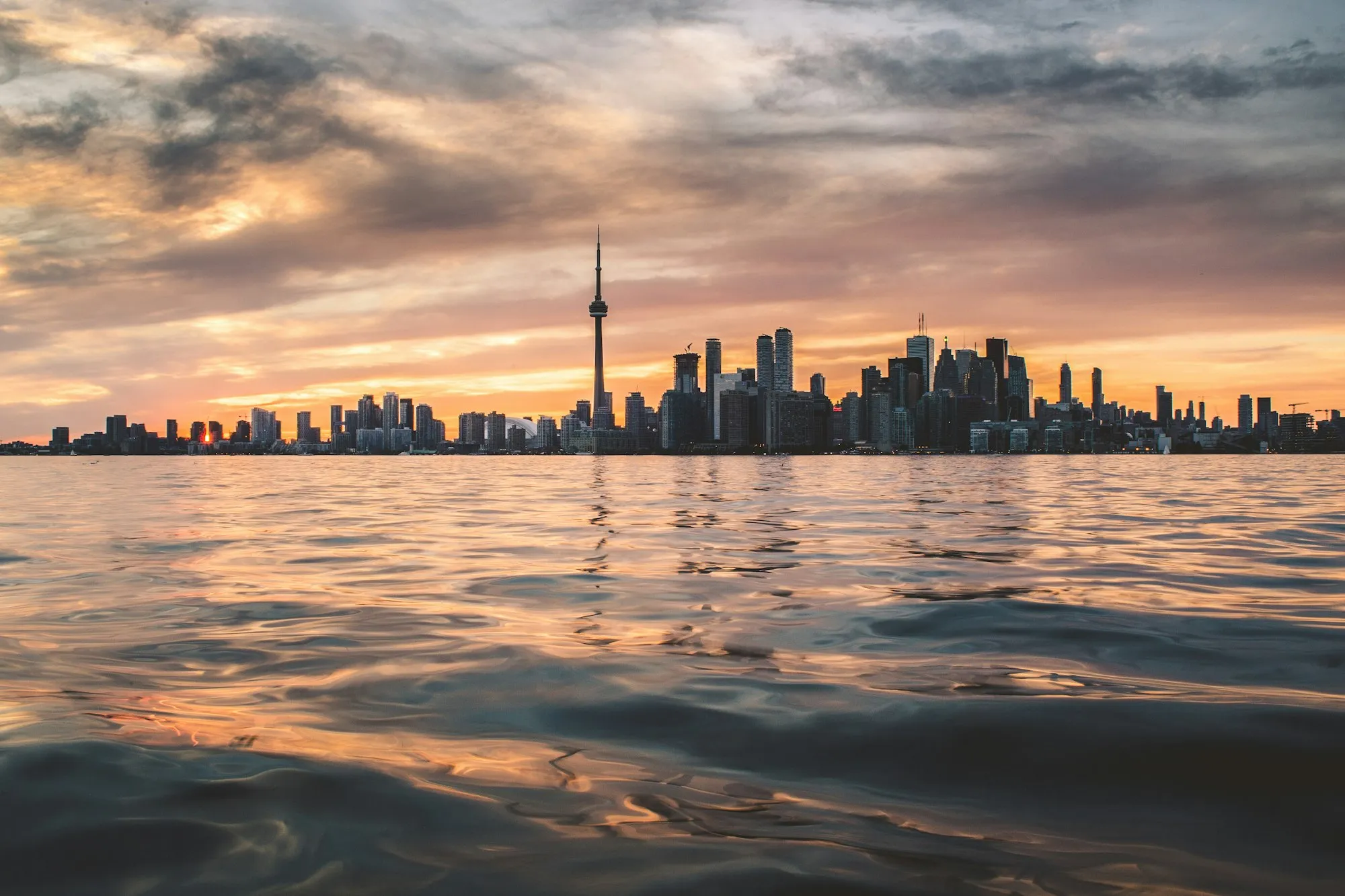 Toronto skyline at sunset over Lake Ontario
